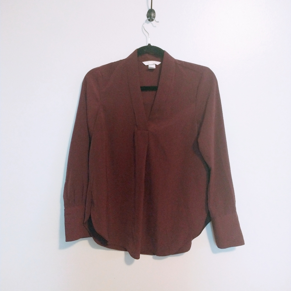 H&M dark red blouse with v neck and long sleeves.  Button detail at cuffs, round